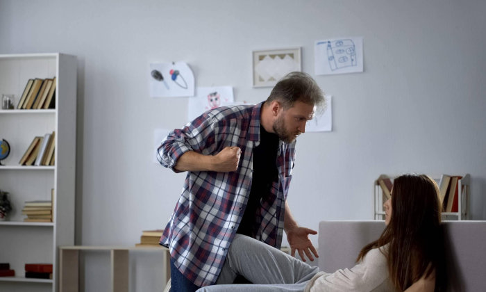 Man with fist toward woman