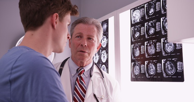 Doctor with a Patient with x-rays in background
