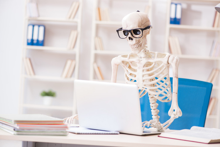 Skeleton at laptop computer