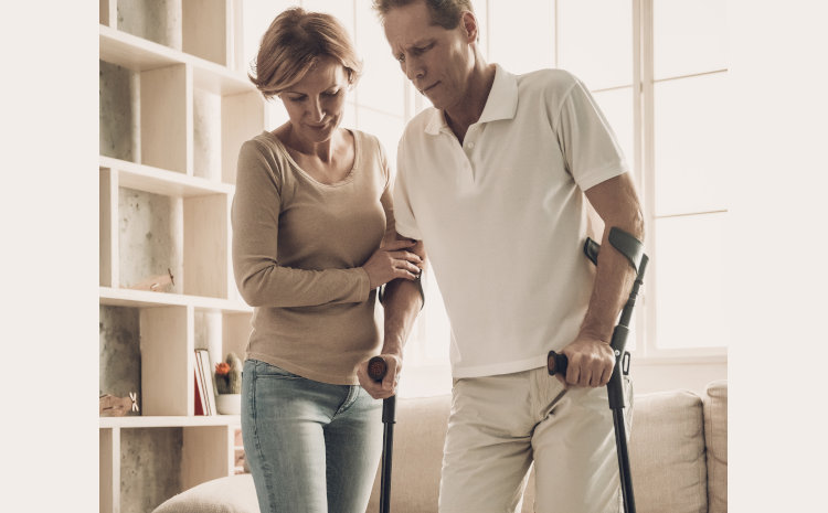 Woman with man on crutches