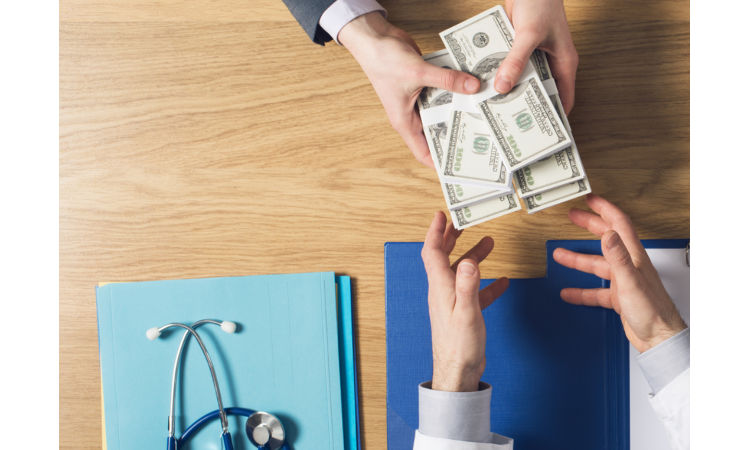Man handing money to doctor