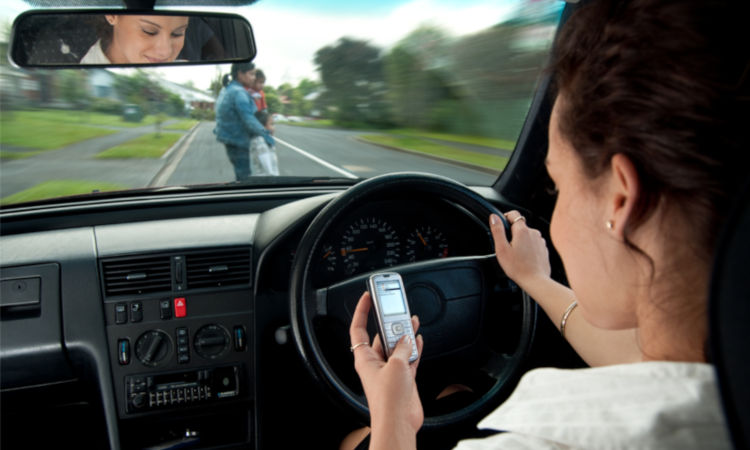 Woman driving while texting