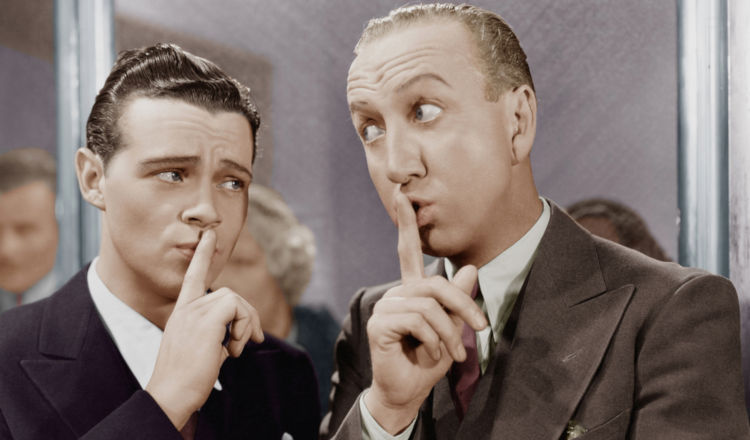 Two guy shushing each other