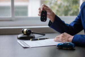 A car accident lawyer holding a car key